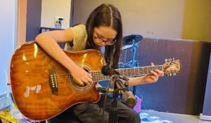 Anna playing guitar at our June show at Busters Bar and Grill.